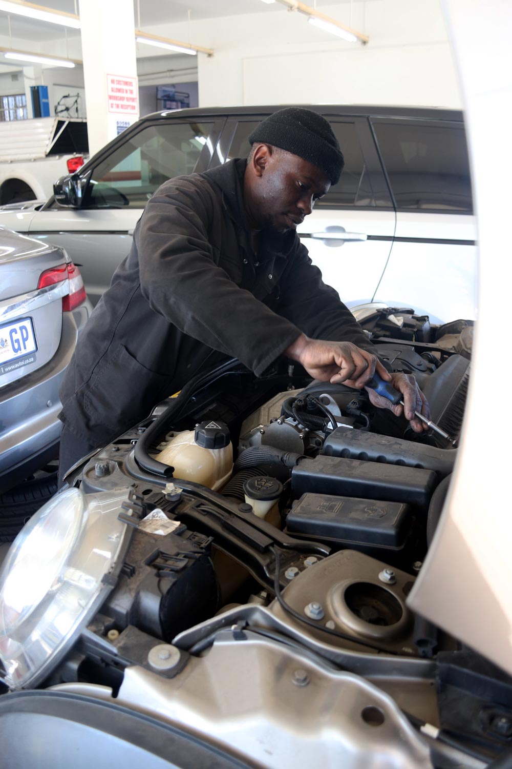 Technician carrying out an engine inspection in the workshop