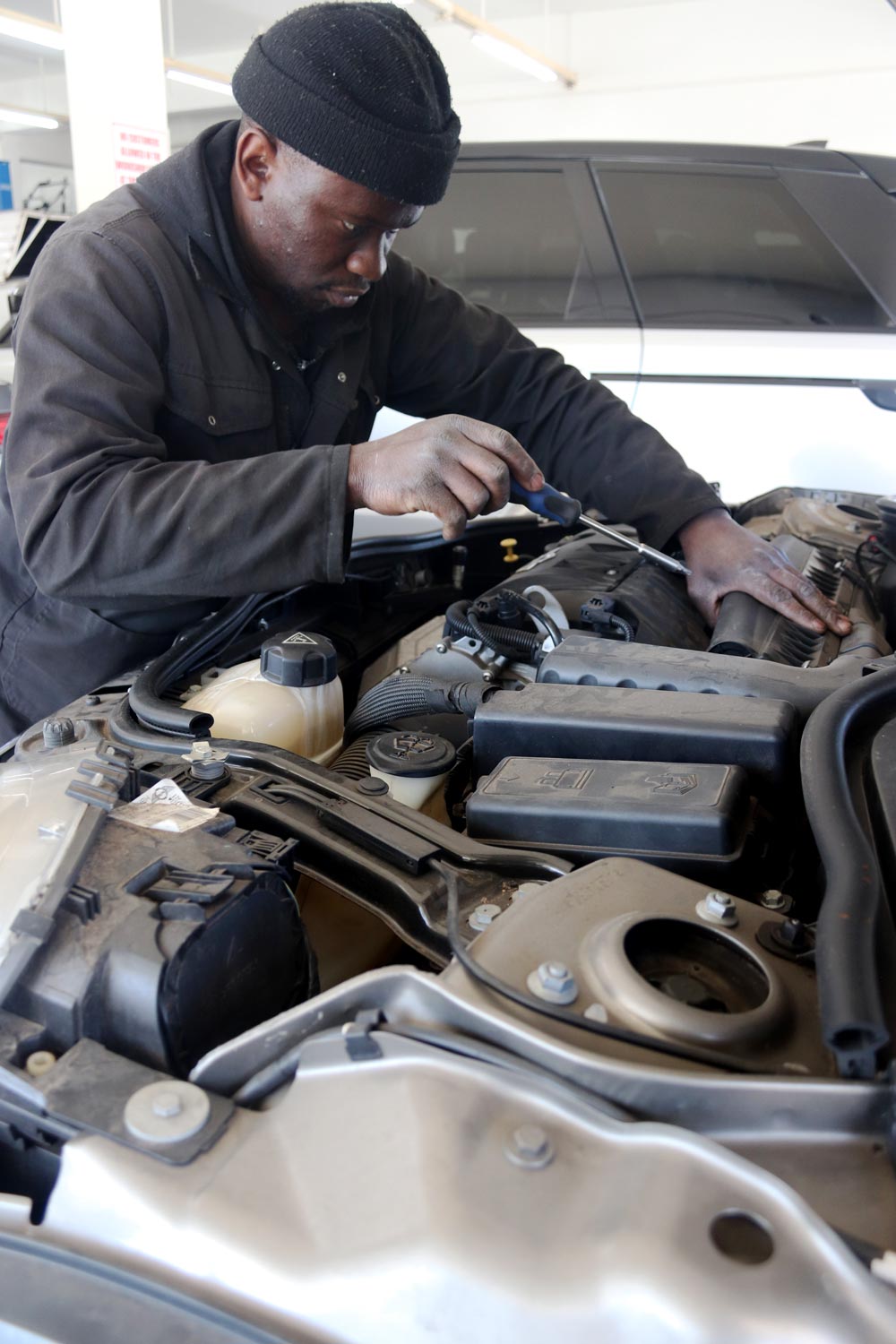 DAD'S Auto technician working on an engine