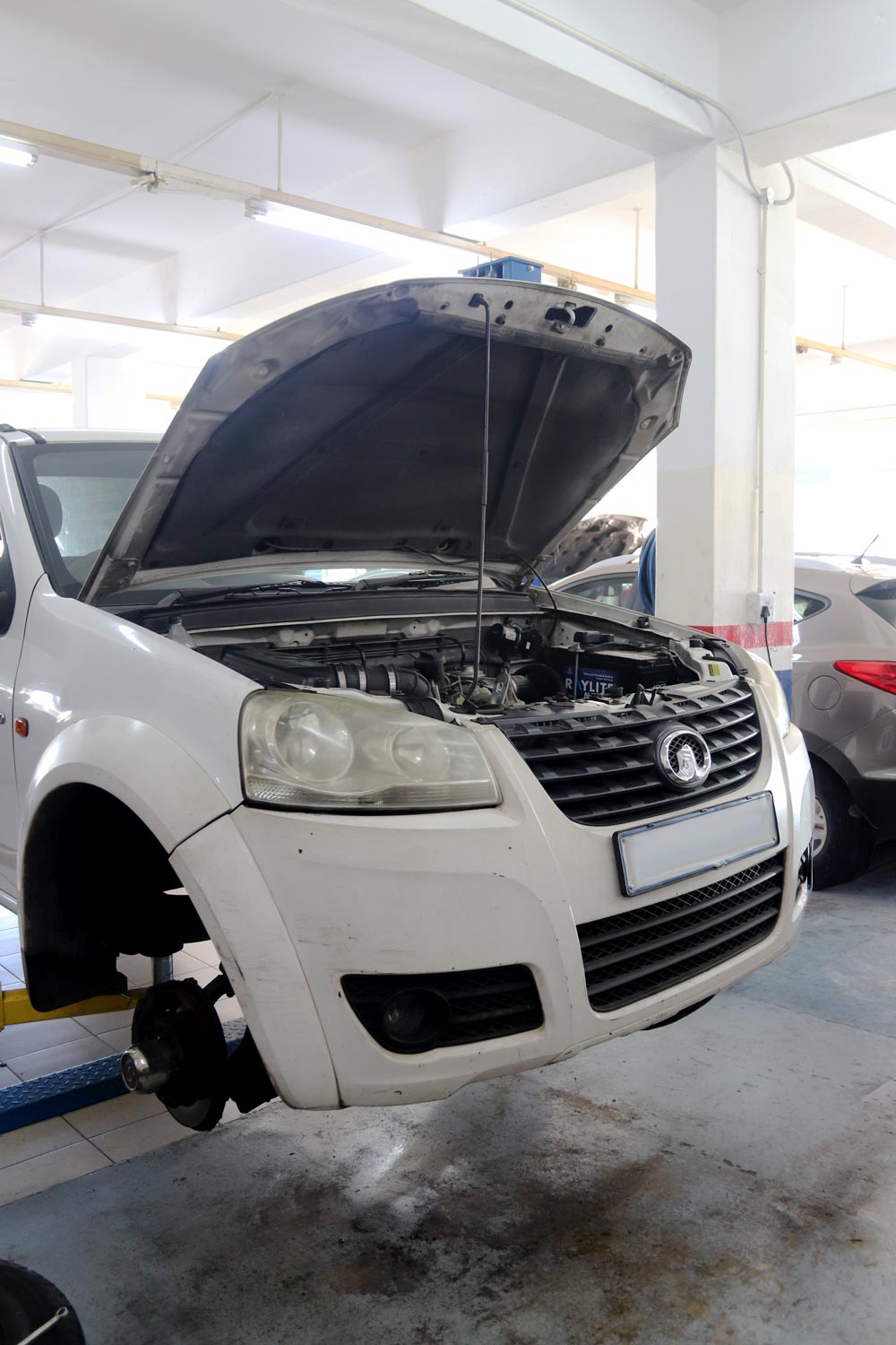 Bakkie on the lift with the bonnet open for servicing